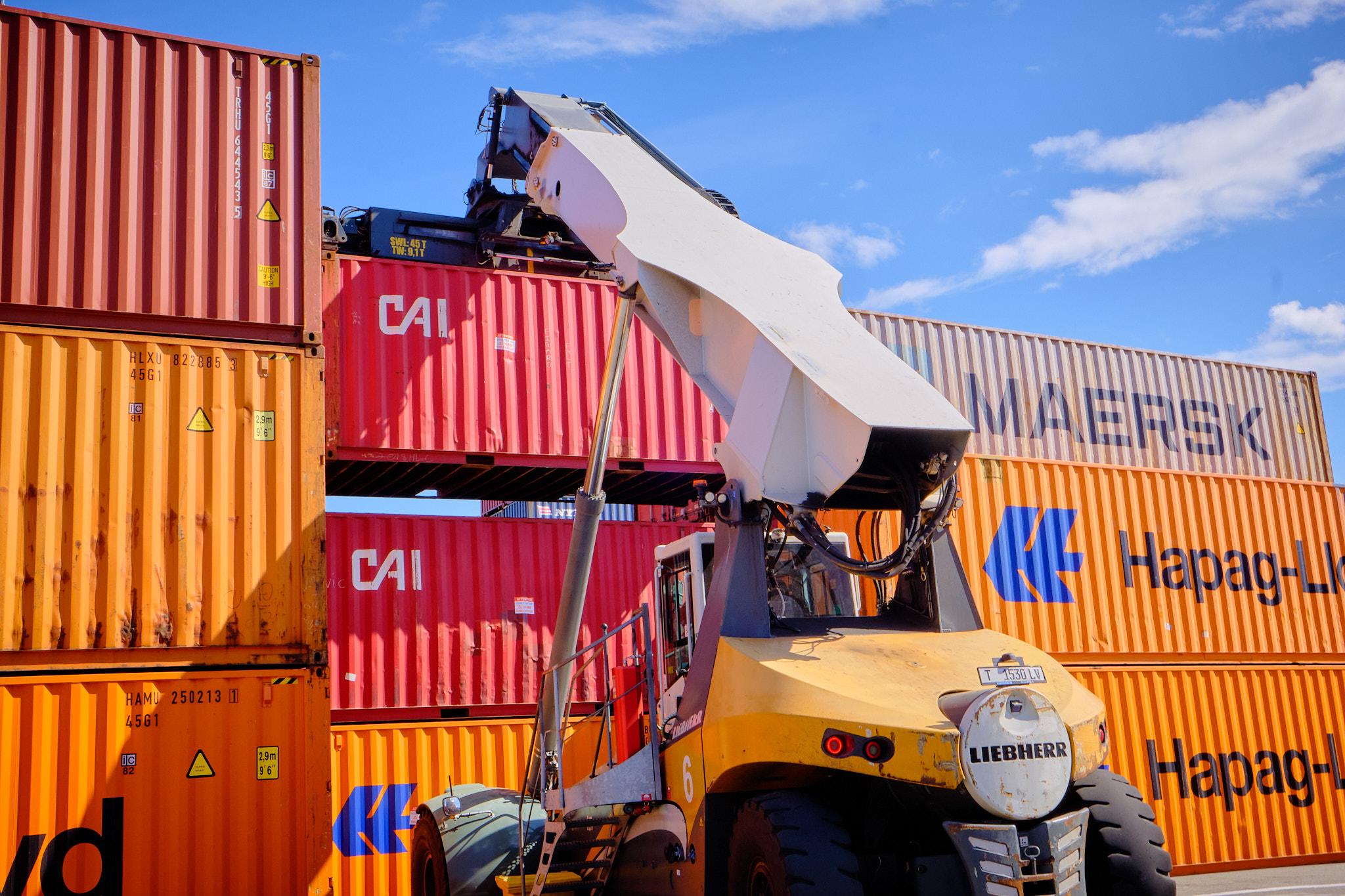 Container handler stacking shipping containers at a terminal