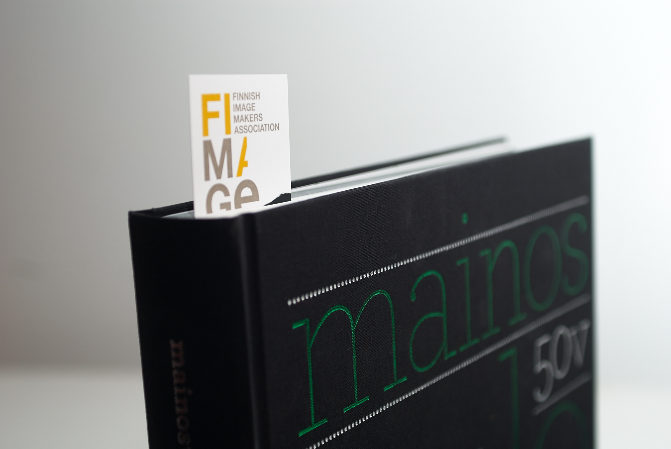 Fimage bookmark card tucked into a book