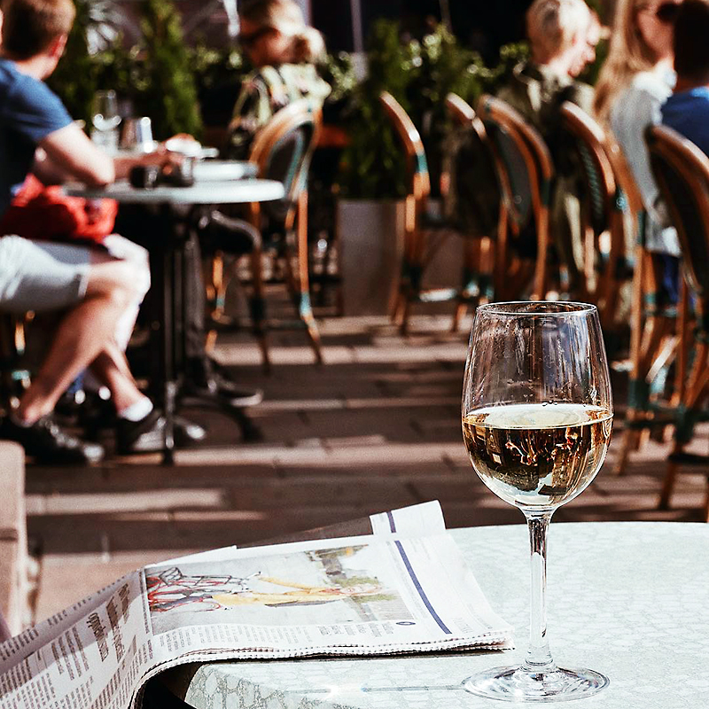 Glass of white wine on a sunny Roasberg terrace